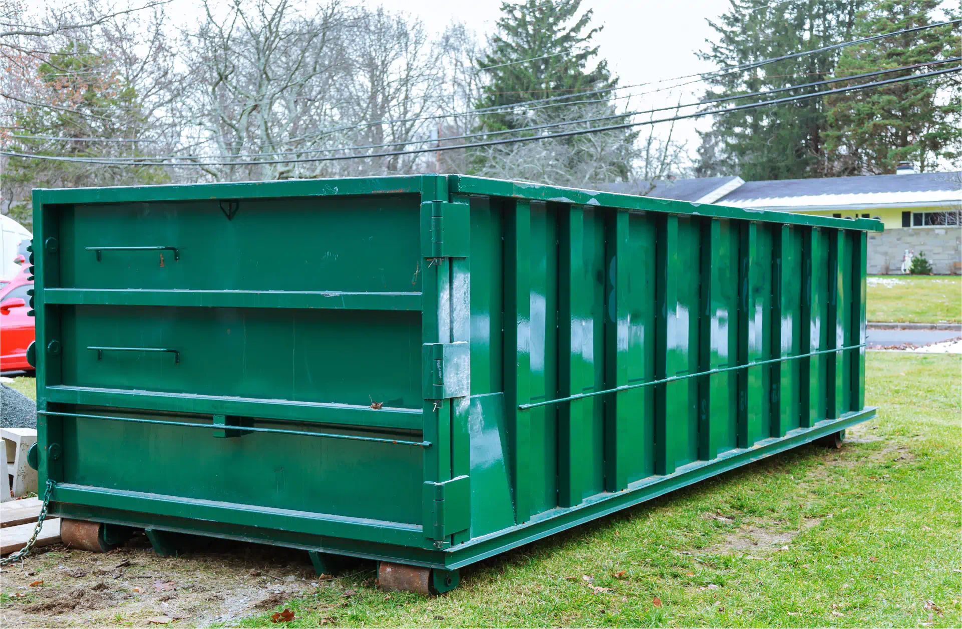 long green dumpster in front yard